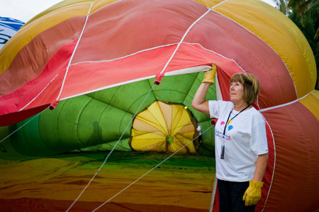 CHIANG MAI, THAILAND - NOV 26: Unidentified woman fill hot air in balloon during Thailand balloon festival 2011 at Prince Royal college in Chiangmai, Thailand on Nov 26, 2011.のeditorial素材