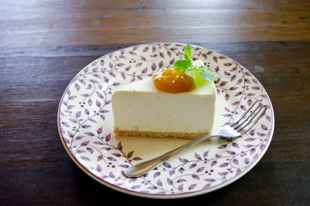 Cheesecake  with mango jam in Japanese style on wooden tableの写真素材