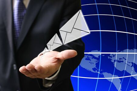Businessman send email to customer around the worldの写真素材