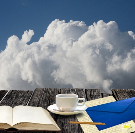 Write a letter with coffee cup on the highest placeの写真素材