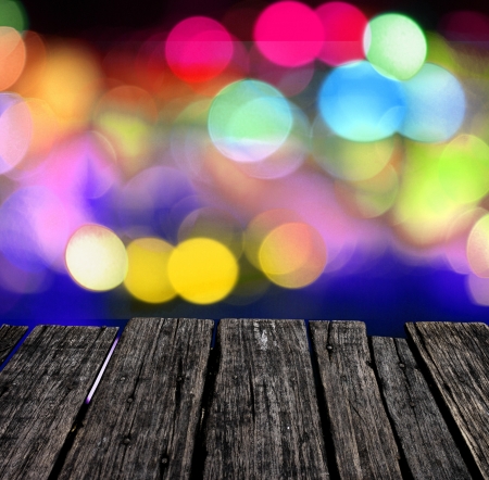 Grunge wooden table with colorful lighting backgroundの写真素材