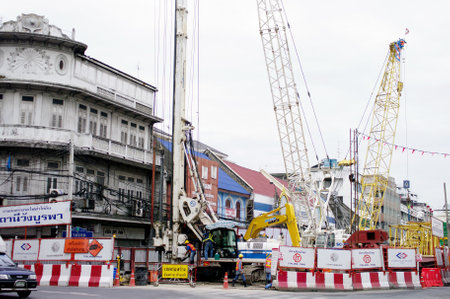 BANGKOK, THAILAND - AUGUST 31 : Machinery working for build subway station on 31 August 2012 at Wang-Burapa junction, Bangkok, Thailandのeditorial素材