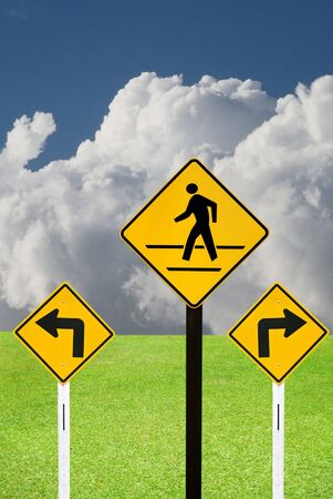Turn sign and crosswalk sign with nice landscapeの写真素材