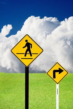 Turn sign and crosswalk sign with nice landscapeの写真素材