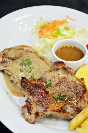 Beef and pork pepper steak with saladの写真素材