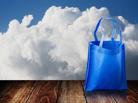 Shopping bag on wooden table with nice skyの写真素材