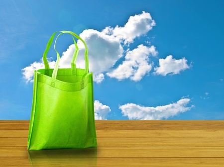 Shopping bag on wooden table with nice skyの写真素材