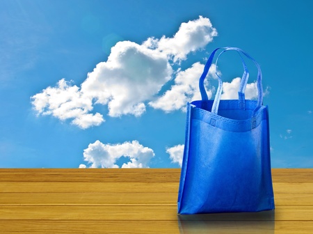 Shopping bag on wooden table with nice skyの写真素材