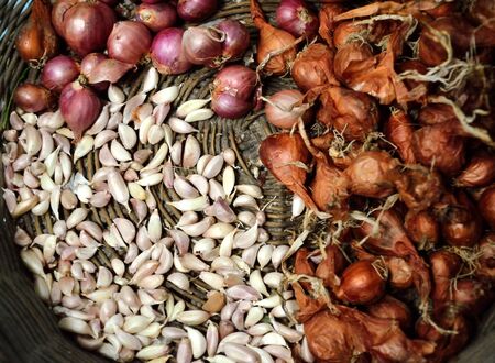 Shallots and garlic in basketの写真素材