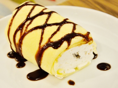 Soft roll cake with chocolate sauceの写真素材