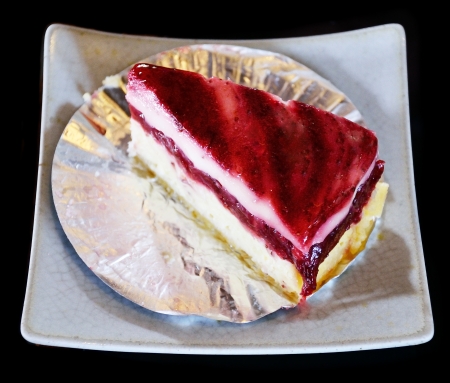 Strawberry cheesecake isolated on black backgroundの写真素材
