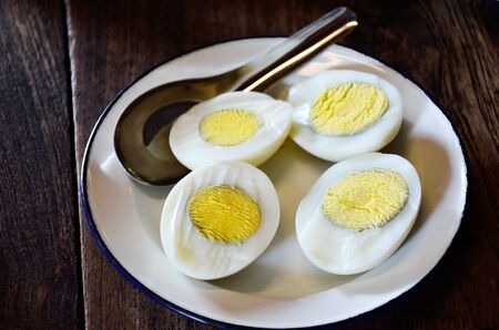 Half of boiled egg in white vintage dishの写真素材