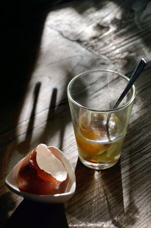 Soft-boiled egg in retro clear glass with morning light の写真素材