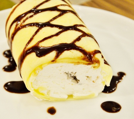 Soft roll cake with chocolate sauceの写真素材