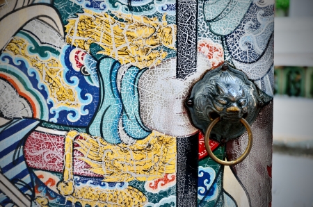 Ancient lion door handle with nice old Chinese art painted, Bangkok, Thailandの写真素材