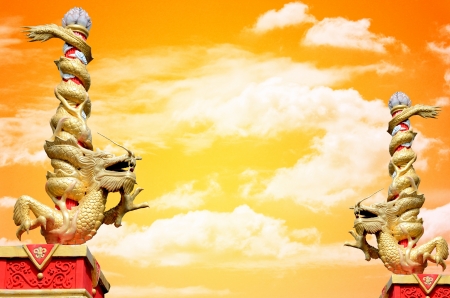 Dragon statue roll the column with sunset sky backgroundの写真素材