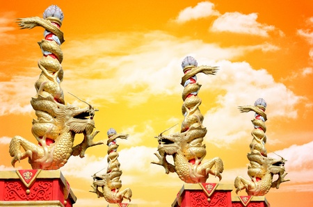 Dragon statue roll the column with sunset sky backgroundの写真素材