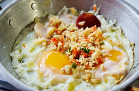 Fried egg with pork and sausage in hot pan, Breakfast in Thai styleの写真素材