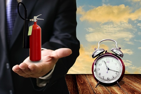 Time to protect the fire concept, Fire extinguisher on handの写真素材