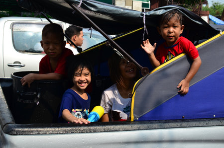 CHIANG MAI, THAILAND - APRIL 12 : Children celebrating Songkran (Thai new year / water festival) in the streets by throwing water at each other on 12 April 2013 in Chiang Mai, Thailandのeditorial素材