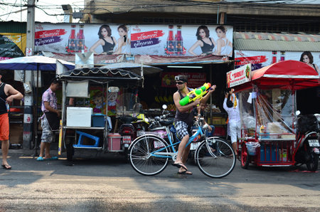 CHIANG MAI, THAILAND - APRIL 12 : Tourist celebrating Songkran with bike in the streets by throwing water at each other on 12 April 2013 in Chiang Mai, Thailandのeditorial素材