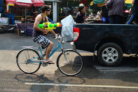 CHIANG MAI, THAILAND - APRIL 12 : Tourist celebrating Songkran with bike in the streets by throwing water at each other on 12 April 2013 in Chiang Mai, Thailandのeditorial素材