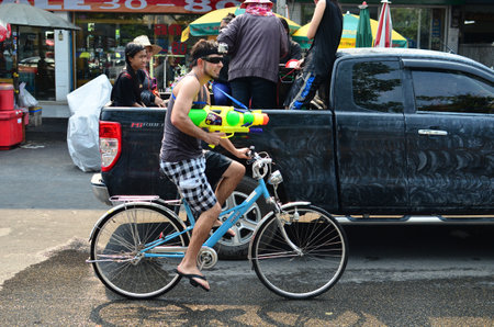 CHIANG MAI, THAILAND - APRIL 12 : Tourist celebrating Songkran with bike in the streets by throwing water at each other on 12 April 2013 in Chiang Mai, Thailandのeditorial素材