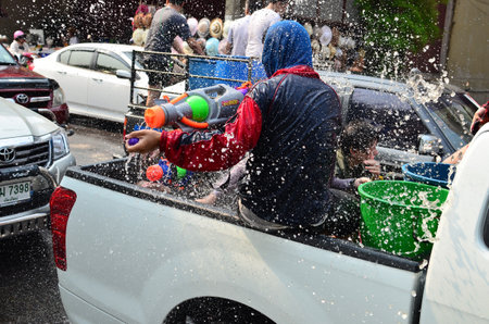CHIANG MAI, THAILAND - APRIL 12 : Unidentified man celebrating Songkran (Thai new year / water festival) in the streets by throwing water at each other on 12 April 2013 in Chiang Mai, Thailandのeditorial素材