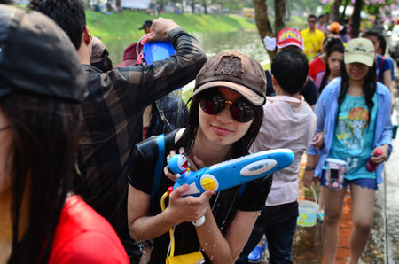 CHIANG MAI, THAILAND - APRIL 12 : Unidentified girl celebrating Songkran (Thai new year / water festival) in the streets by throwing water at each other on 12 April 2013 in Chiang Mai, Thailandのeditorial素材