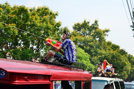 CHIANG MAI, THAILAND - APRIL 13 : Tourists sit on bus roof for celebrating Songkran (Thai new year / water festival) on 13 April 2013 in Chiang Mai, Thailandのeditorial素材