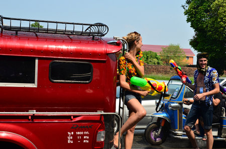 CHIANG MAI, THAILAND - APRIL 13 : Tourist stand on bus for celebrating Songkran (Thai new year / water festival) on 13 April 2013 in Chiang Mai, Thailandのeditorial素材