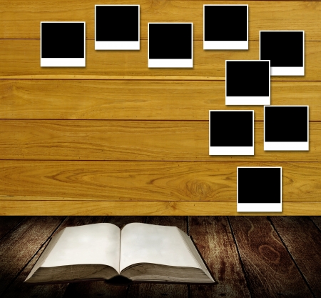Reading book with photo frames post on wooden wall, Reading table conceptの写真素材