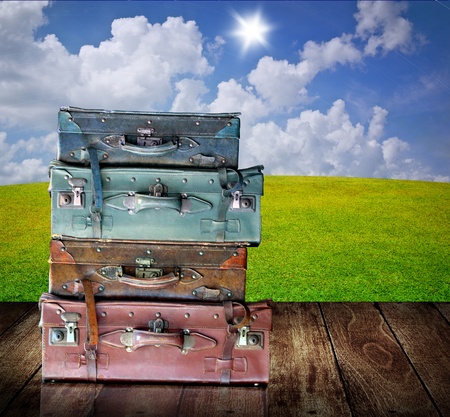 Vintage luggage on wooden table with nice landscape background, Travel in the countryside conceptの写真素材
