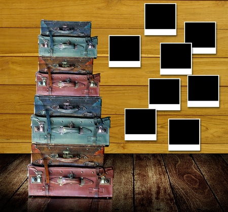 Retro travel concept, Old travel bags with photo frames post on wooden wallの写真素材