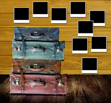 Retro travel concept, Old travel bags with photo frames post on wooden wallの写真素材