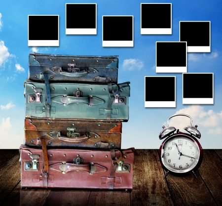 Plan for vacation concept, Travel bag and alarm clock on table with photo frame post on wallの写真素材