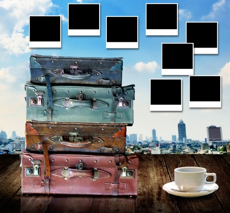 Travel memories concept, Vintage travel bag and photo frame with city view backgroundの写真素材
