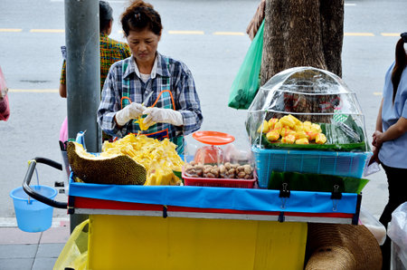 BANGKOK, THAILAND - OCTOBER 2 : Unidentified woman sell jackfruit beside street on 2 October 2012 in Bangkok, Thailandのeditorial素材