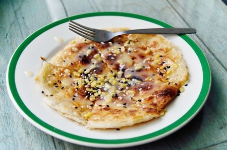 Southern flat bread with sweetened condensed milk and seasame の写真素材