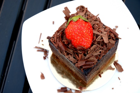 Chocolate cake with strawberry on the white plateの写真素材
