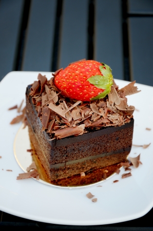 Chocolate cake with strawberry on the white plateの写真素材