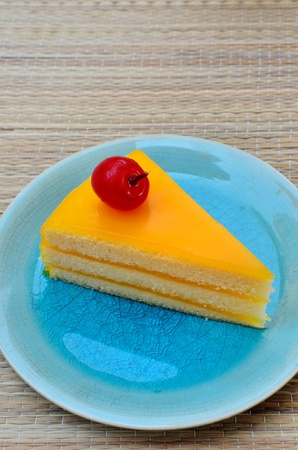 Orange cake in blue dish, Sweet dessertの写真素材