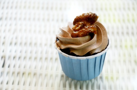 Cupcake with caramel walnut on tableの写真素材