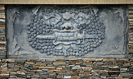 Lion with sword in mouth stucco on wall, Chinese styleの写真素材