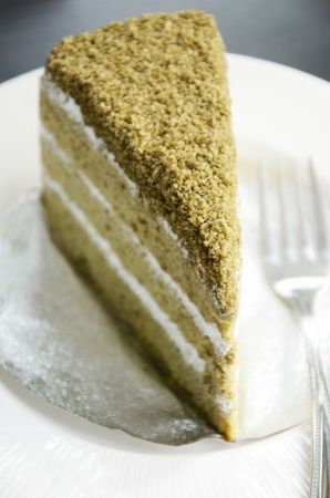 Matcha green tea cake in white dishの写真素材