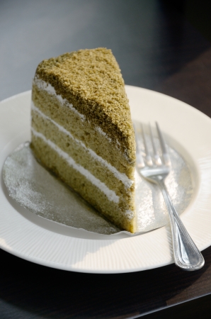 Matcha green tea cake in white dishの写真素材