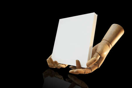 Wooden figure handheld picture on black backgroundの写真素材