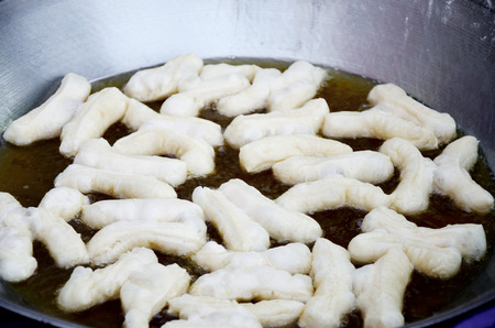 Deep-fried dough stick in hot oil, Chinese dessertの写真素材