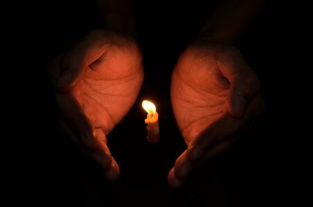 Candle light in hand, Hope conceptの写真素材