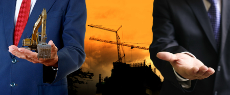 Businessman offer the machinery to site, Construction business conceptの写真素材